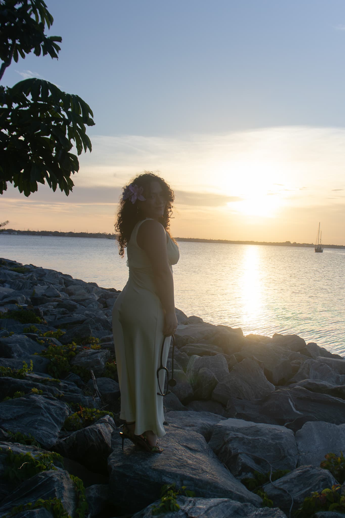 Graduation portrait on coastal rocks at sunset